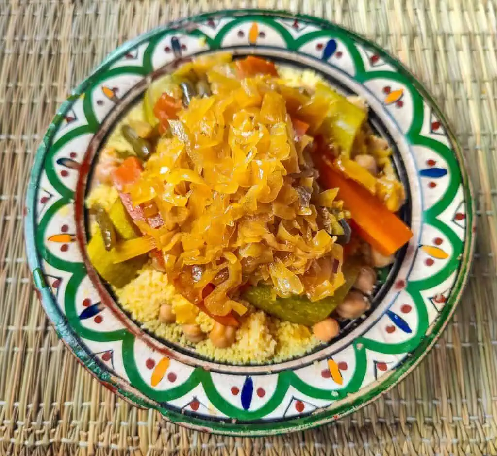 Aerial view of vegetarian couscous in a colorful dish from Assaada