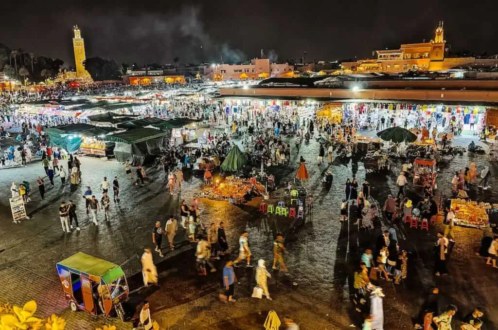 An aerial view of people walking around in the evening in Jemma el-Fna Square in Marrakech. This is one of the best free things to do in Marrakech at niight.