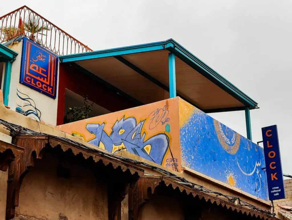 The orange and blue sign and porch with street art in front of Cafe Clock. This is where I got picked up for my hot air balloon ride in Marrakech.