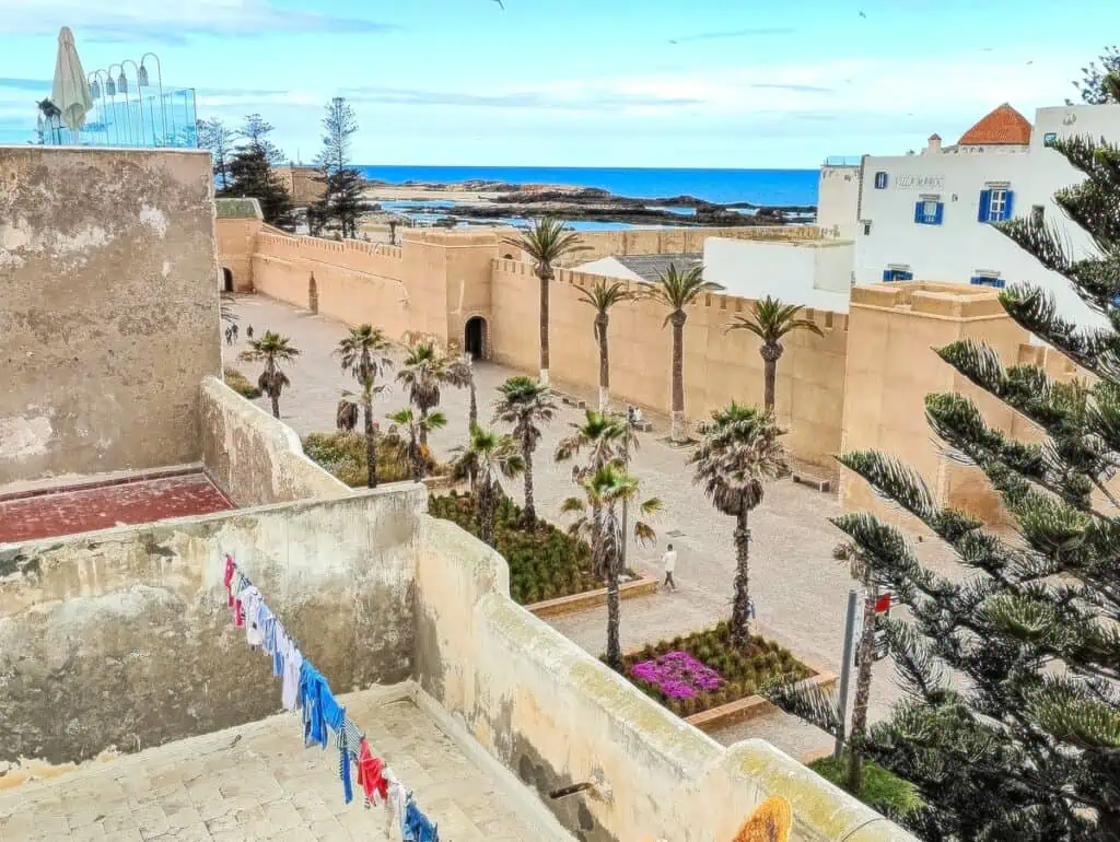 View of the ocean from the roof of KSOU rooftop and cafe. You can see clothes hanging, the Medina, and the ocean in the distance.