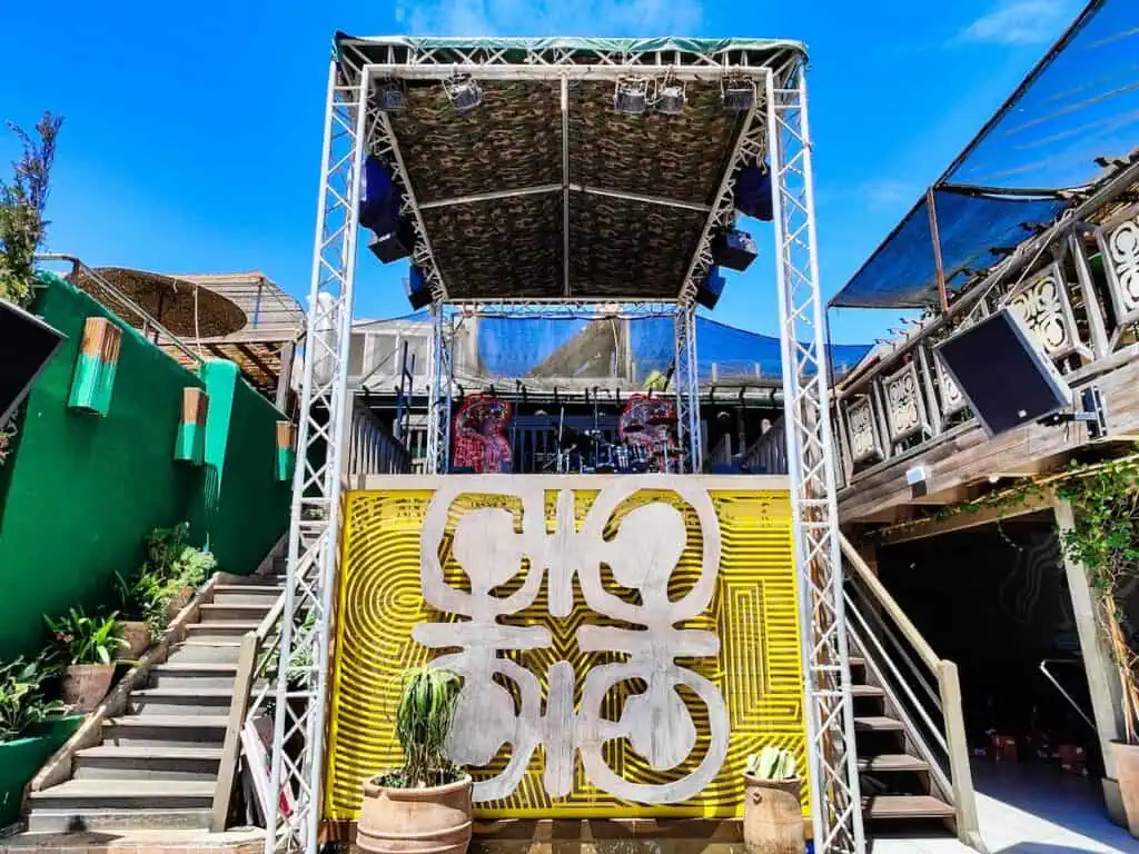 A view of the DJ stand on Taros which si yellow with a white sign.