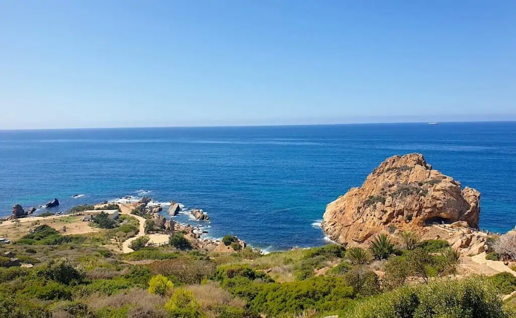 View of the rocks and grass along the coast near Cap Spartel. Look out and you get beautiful views of the ocean on a sunny day.