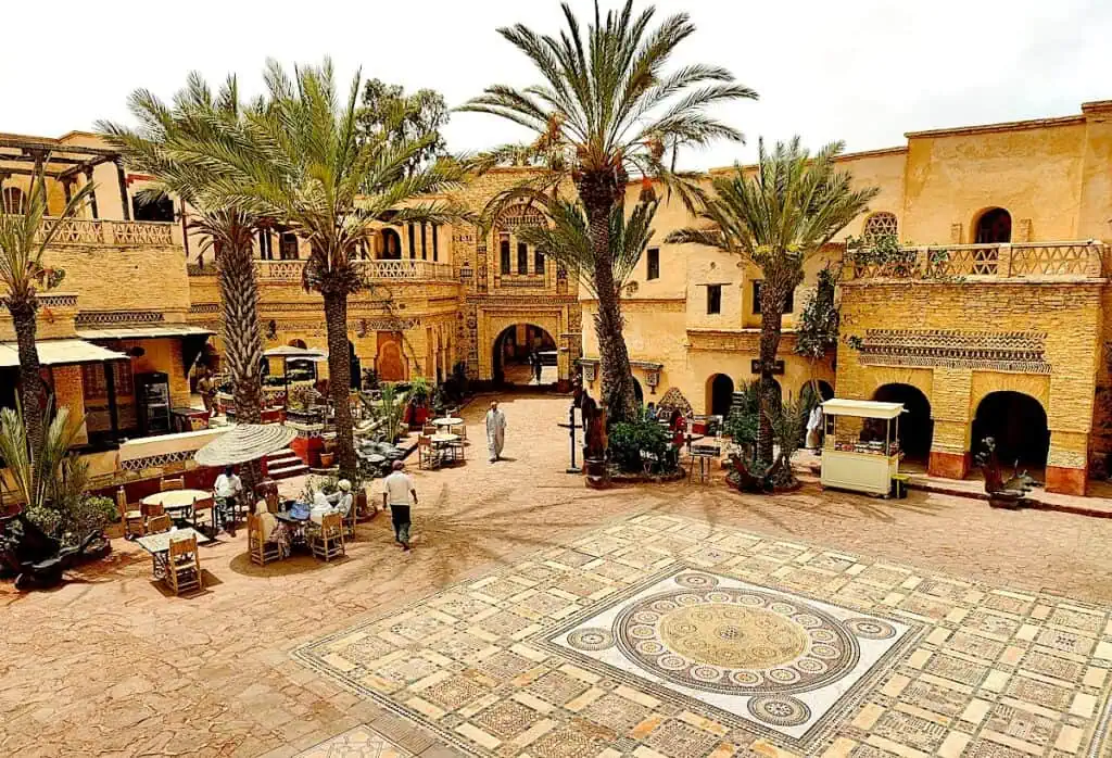 View of the tilework, central courtyard and palm trees in the recreation of the Medina in Agadir. Historic buildings are something to consider when looking at Marrakech or Agadir.