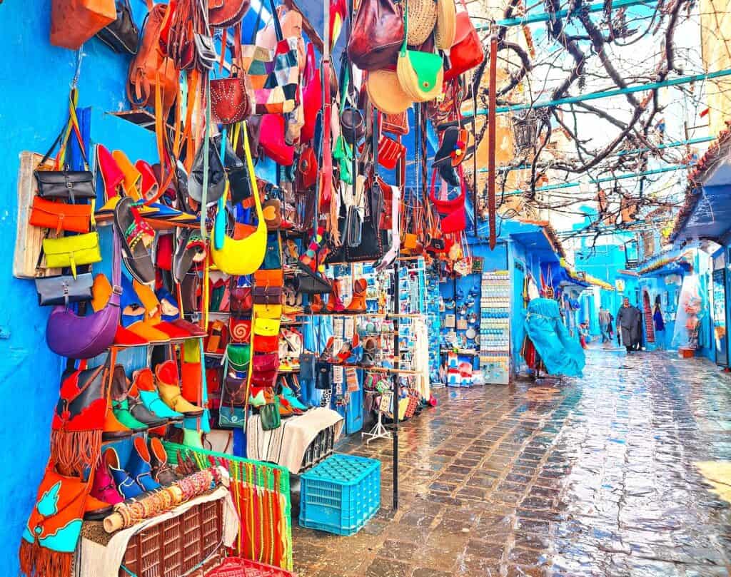 View of colorful souvenirs for sale inside the blue Medina of Chefchaouen.