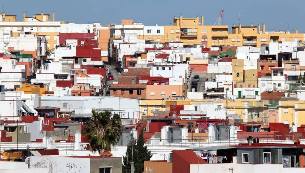 View of the beautiful yellow and red-roofed homes that you'll find in Algeciras in Spain. This is one of the places you can take the ferry from Spain to Tngier. 
